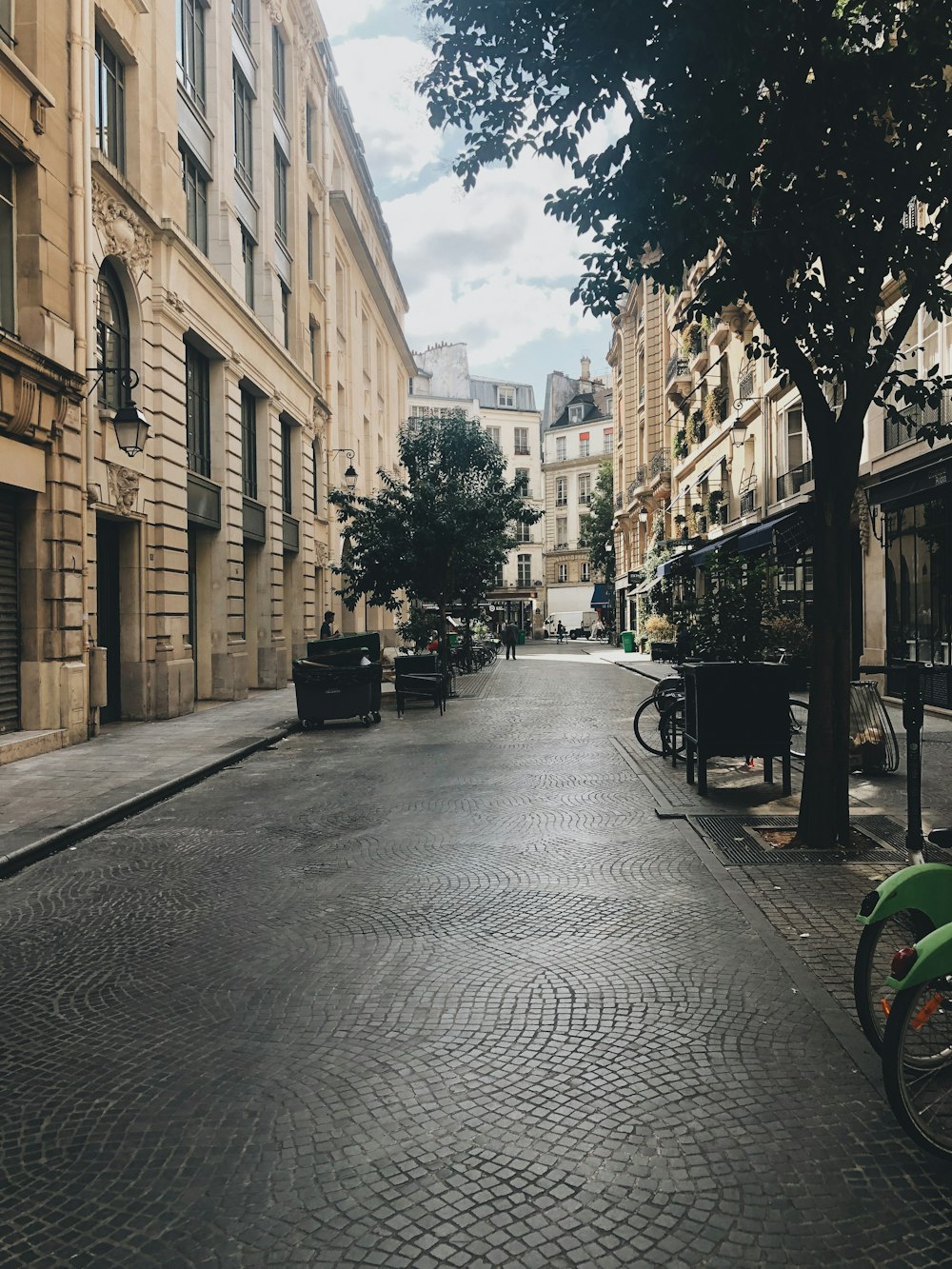 black bicycle parked beside brown concrete building during daytime