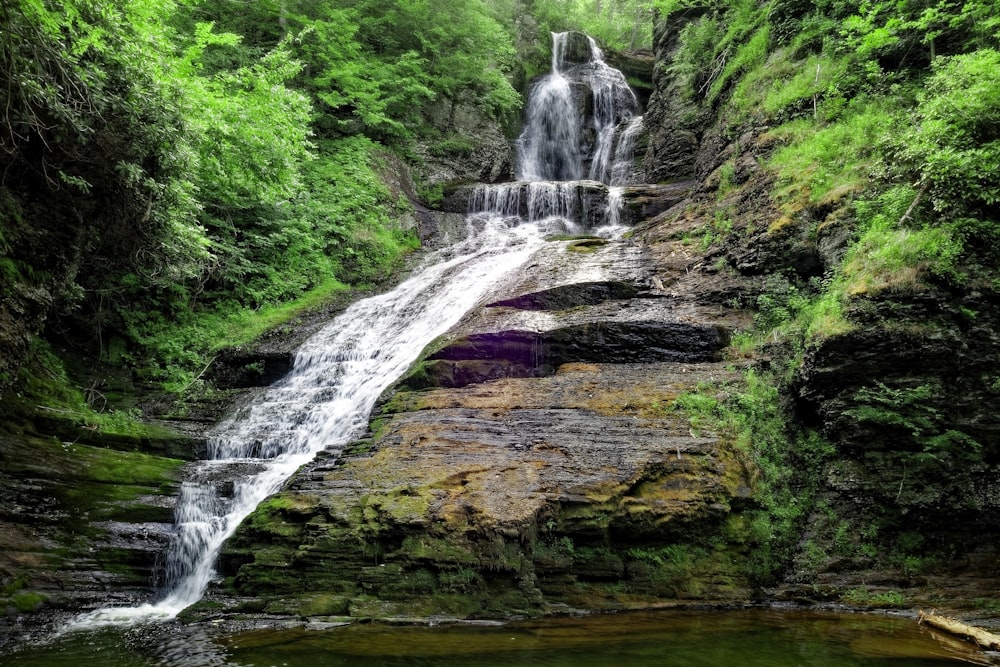 waterfalls on brown rocky mountain during daytime