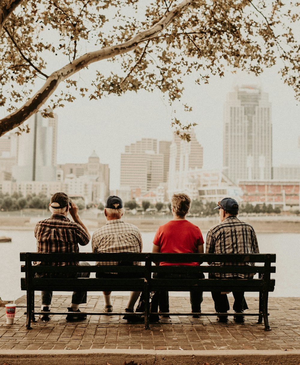 man and woman sitting on bench during daytime