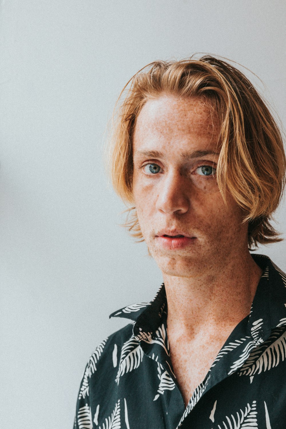 man in black and white floral button up shirt