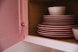 white ceramic bowl on white wooden shelf