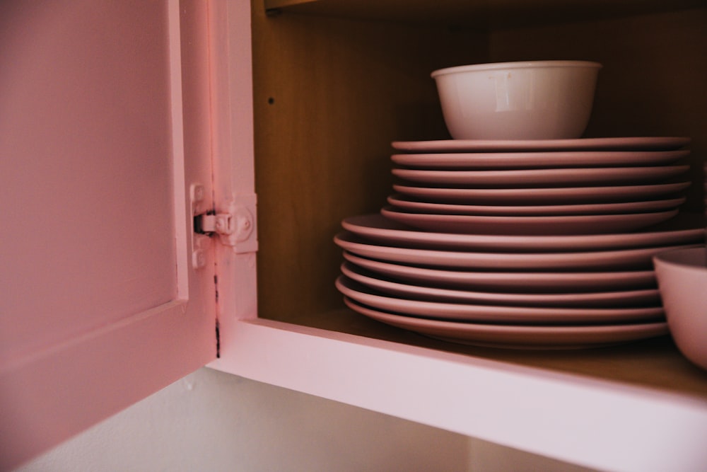 white ceramic bowl on white wooden shelf