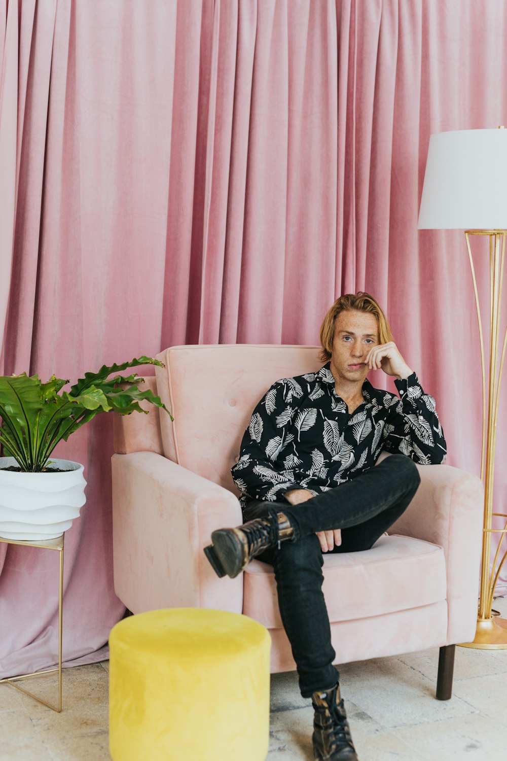 woman in black and white floral long sleeve shirt sitting on white sofa chair