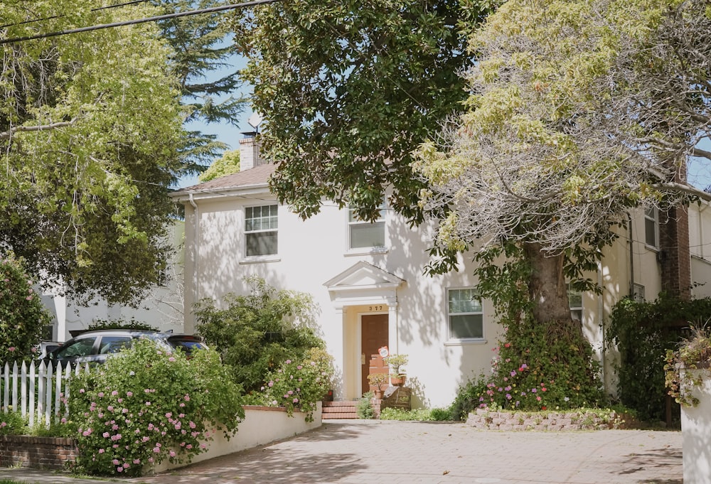 white concrete house near green trees during daytime