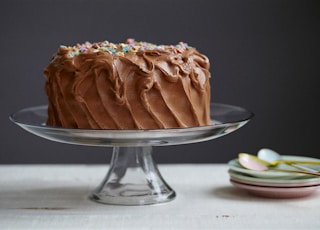 brown cake on clear glass cake stand