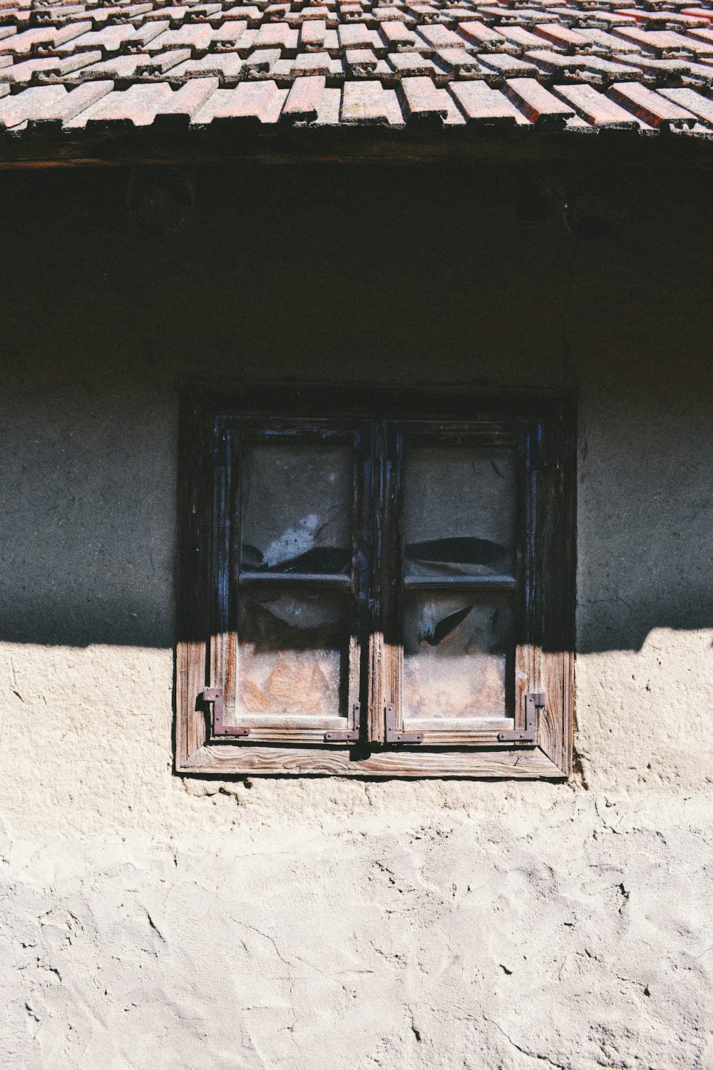 brown wooden window on white concrete wall