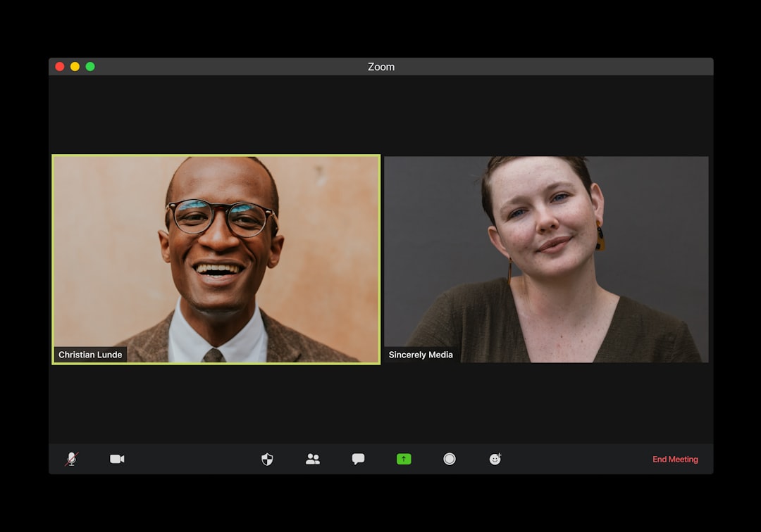 man in black suit jacket smiling, Zoom (Video chat)