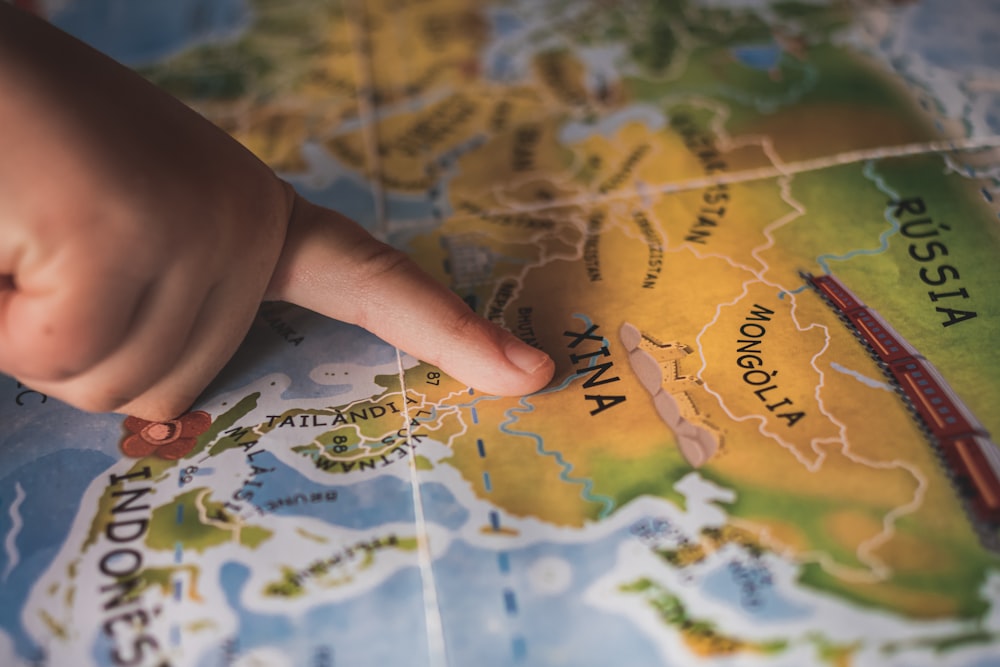 person holding yellow and green map