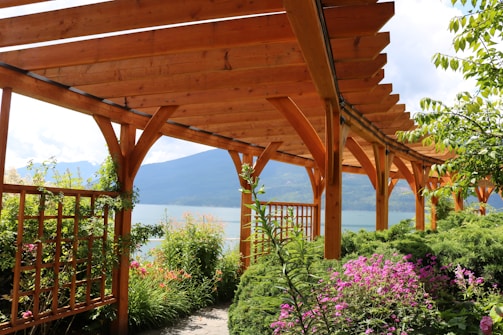 brown wooden bridge over body of water during daytime