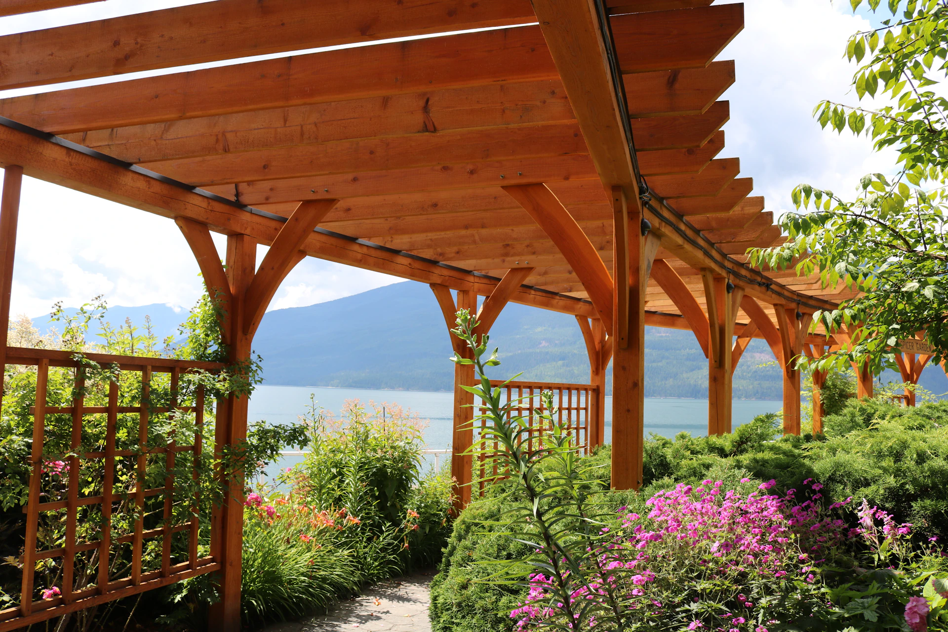 brown wooden bridge over body of water during daytime