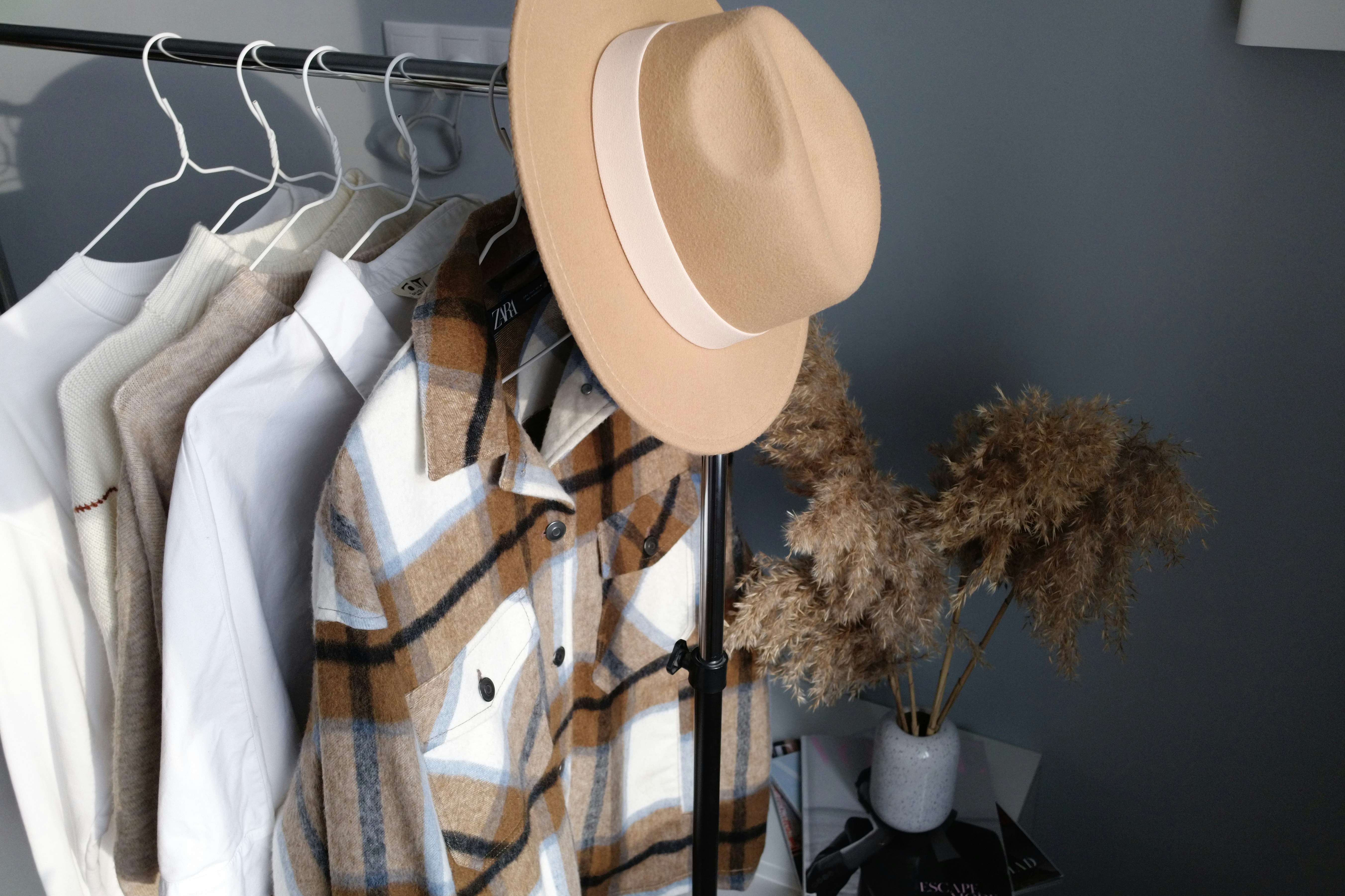 White fedora hat hanged on black metal rack photo – Free Brown Image on ...