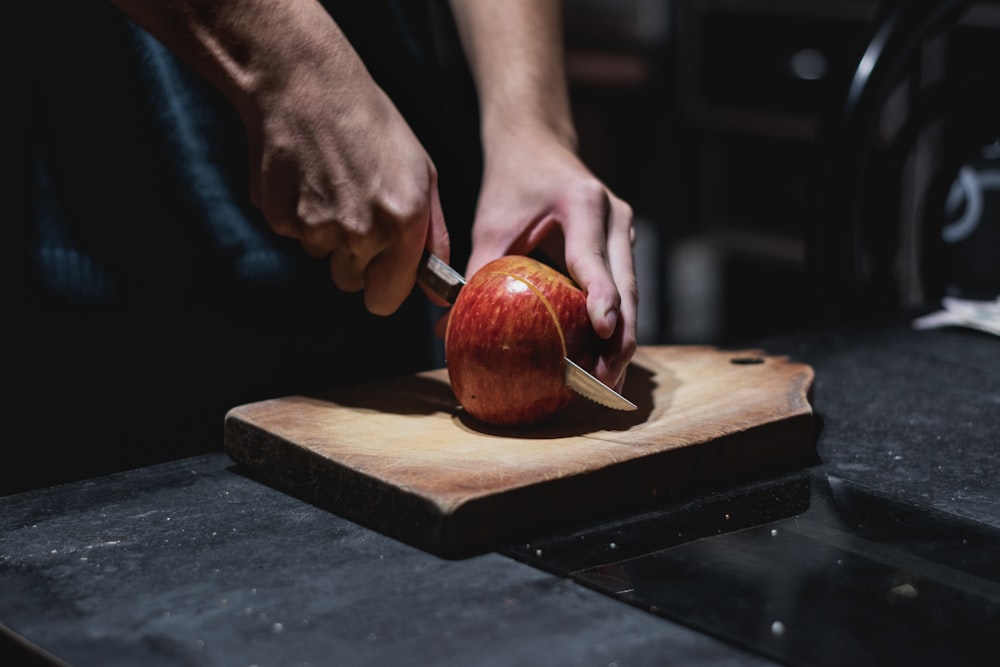 person holding red apple fruit