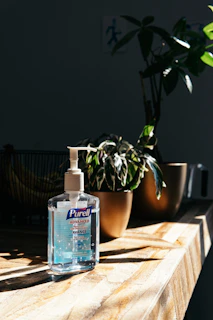 Close-up of a Purevanta team member carefully sanitizing a conference room table.