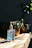 Close-up of hands wiping a wooden table with a Purevia cleaning wipe.