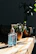 Close-up of hands wiping a wooden table with a Purevia cleaning wipe.