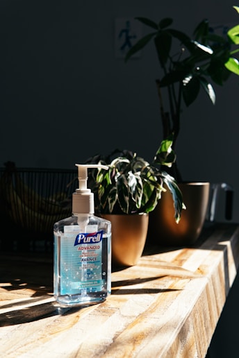 white plastic pump bottle on brown wooden table