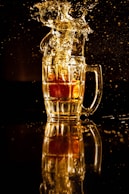 clear glass mug with brown liquid