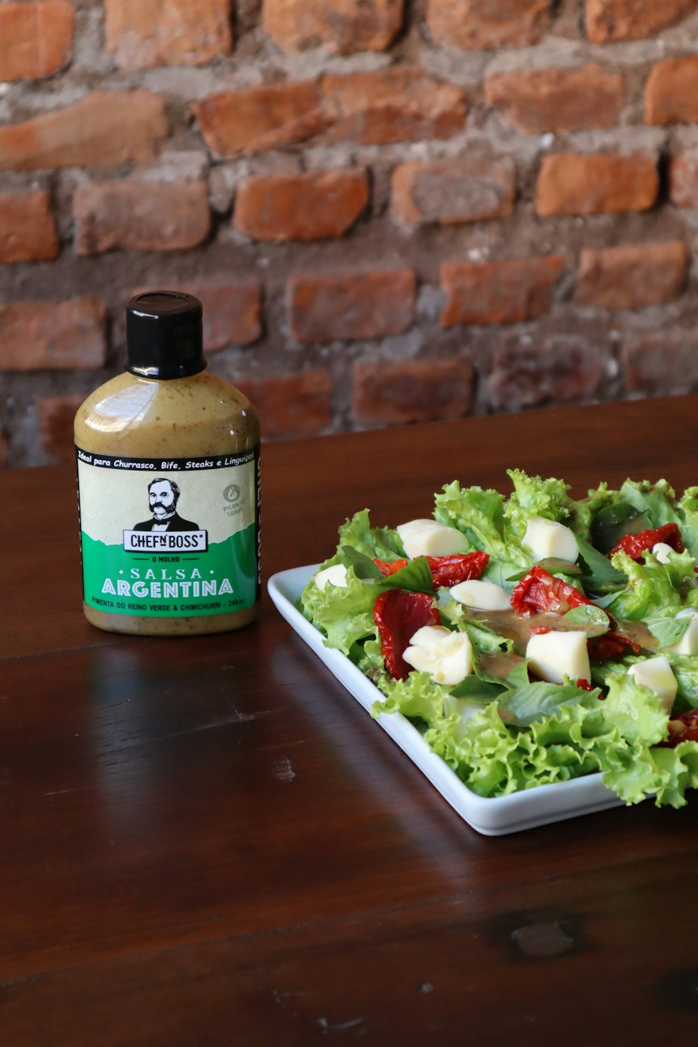 green and white plastic bottle on brown wooden table