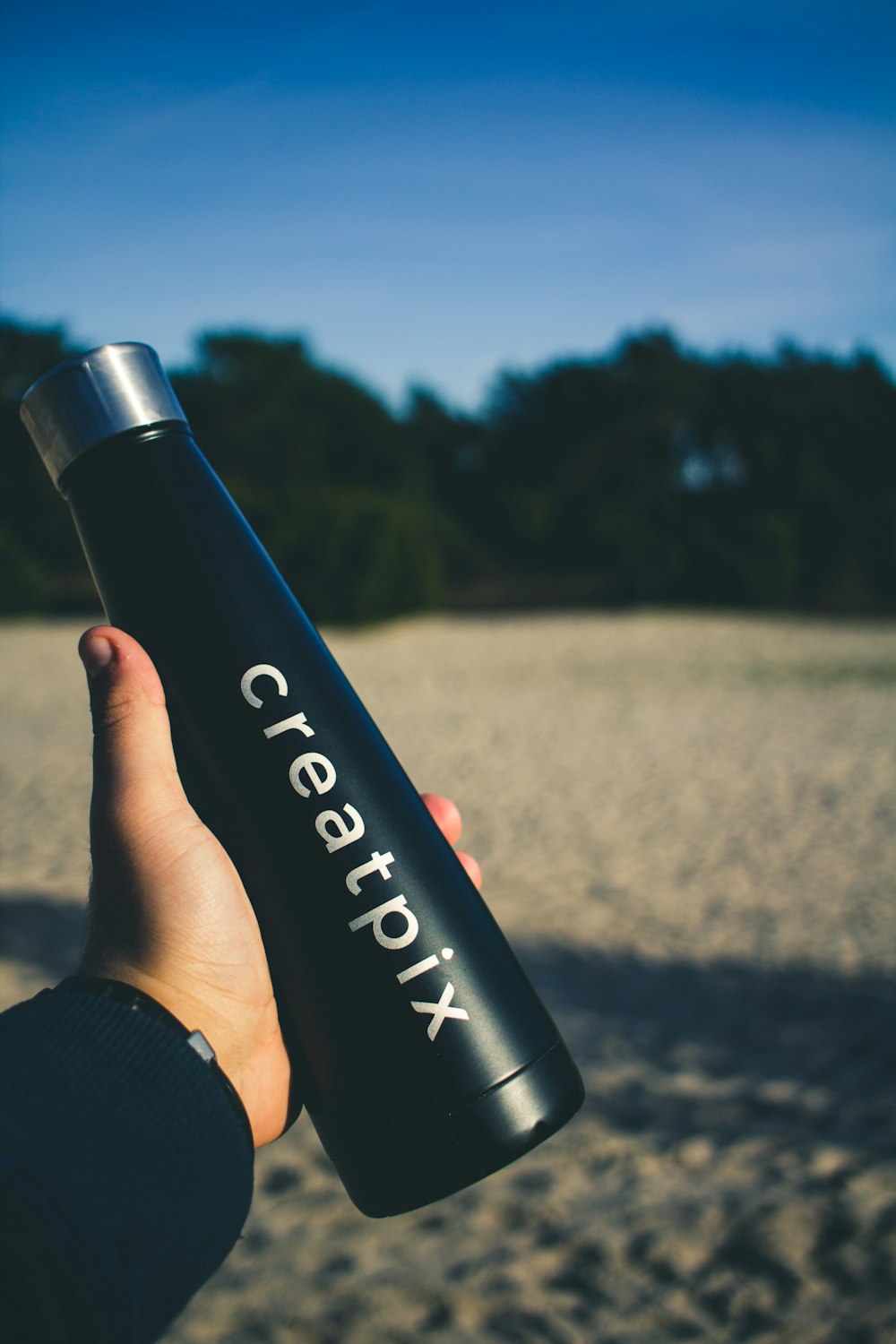 person holding black calvin klein bottle