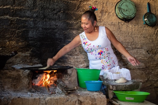 woman in white and pink floral tank top cooking