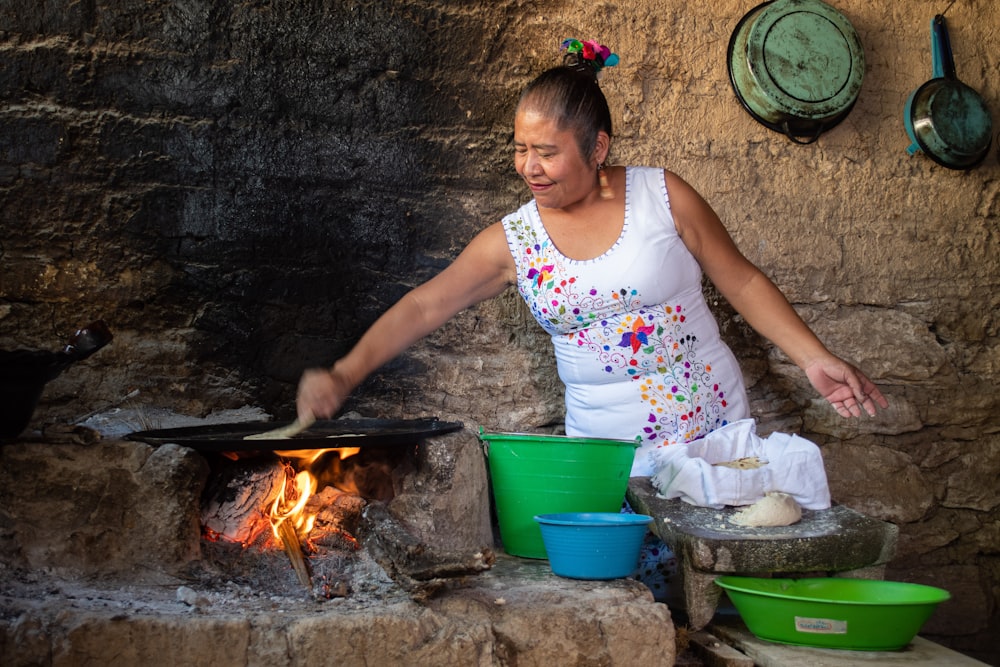 woman in white and pink floral tank top cooking