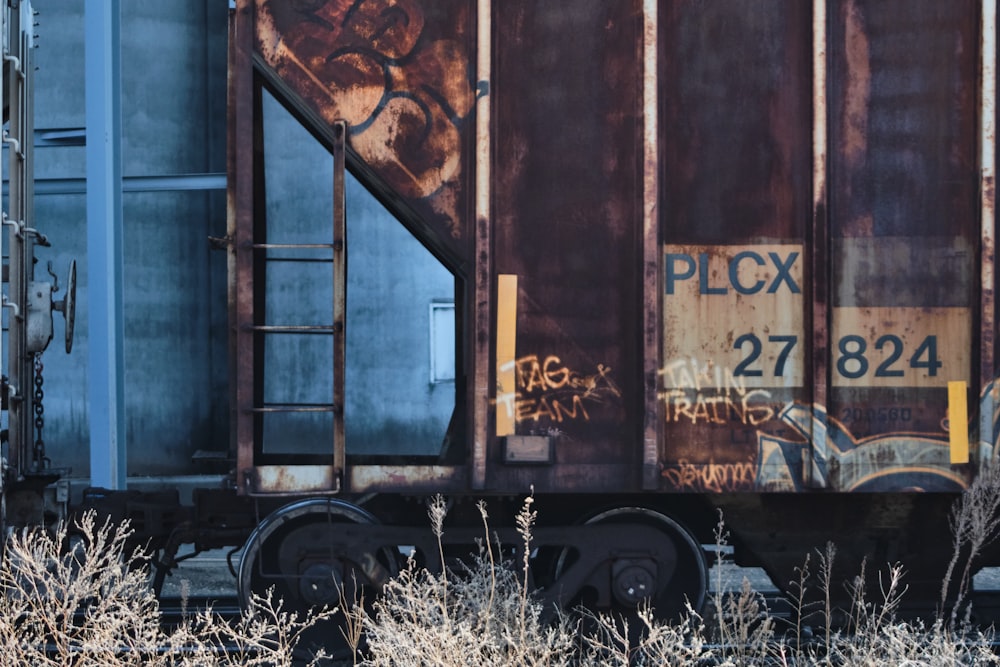 brown wooden wall with graffiti