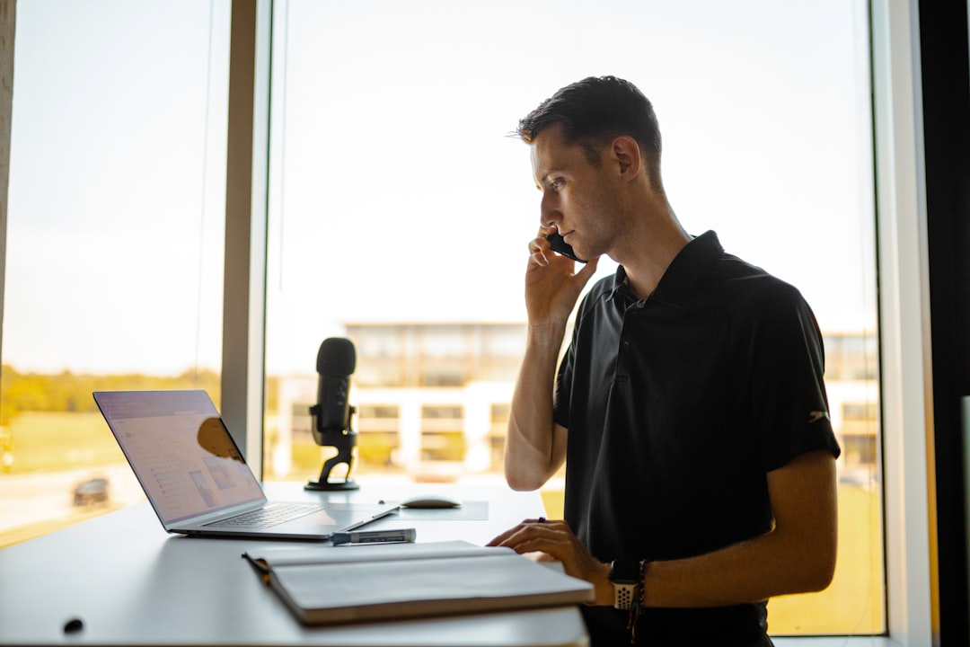 man in black polo shirt sitting at the table