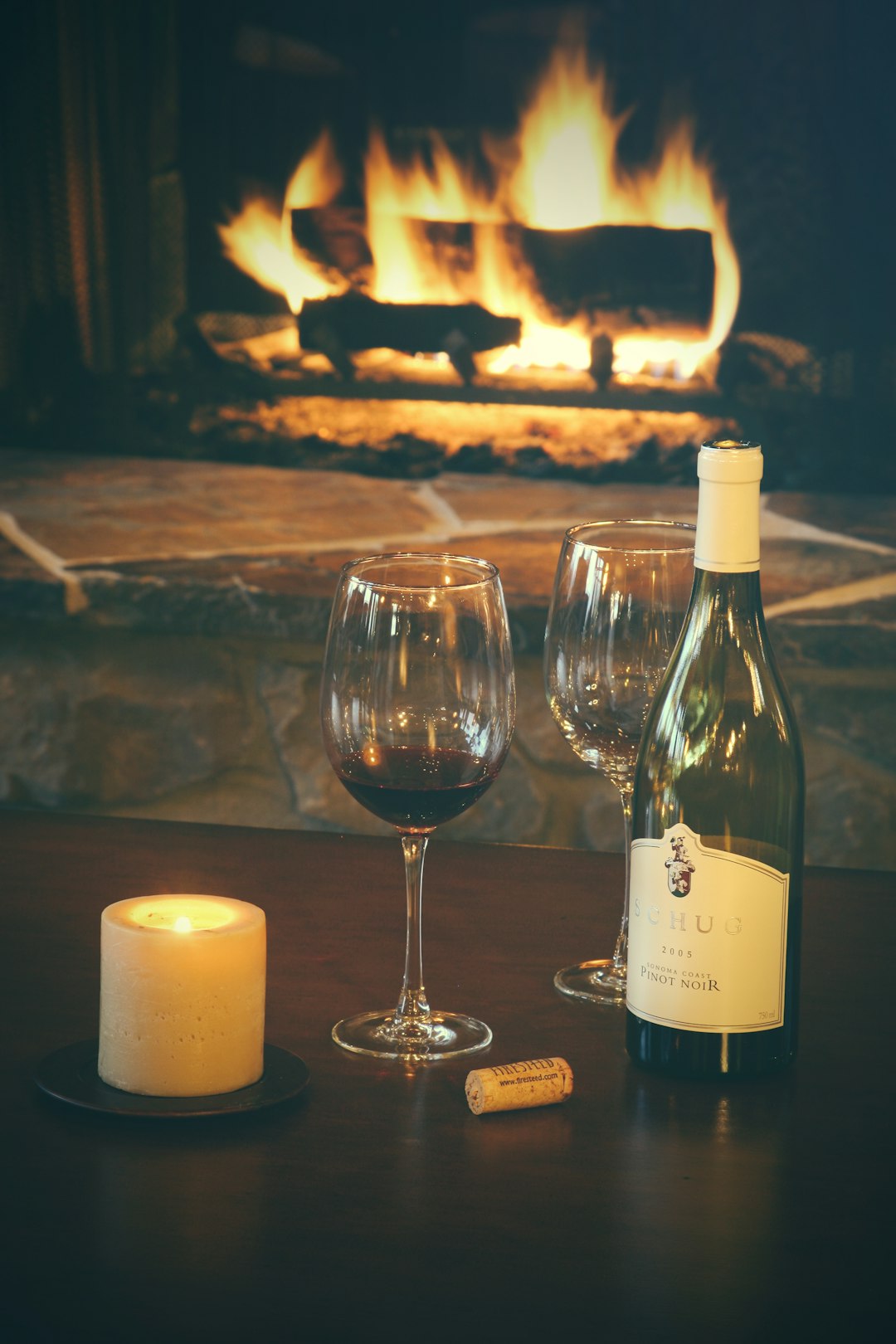 clear wine glass beside white candle