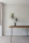 Close-up of a minimalist birch end table with clean lines, styled with a small plant and a modern lamp.