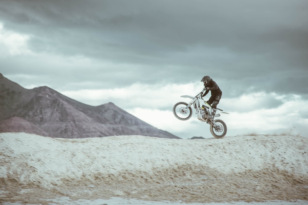 man in black jacket riding on bicycle during daytime