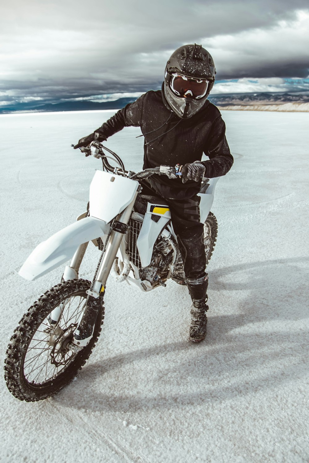 man in black jacket riding white motorcycle during daytime