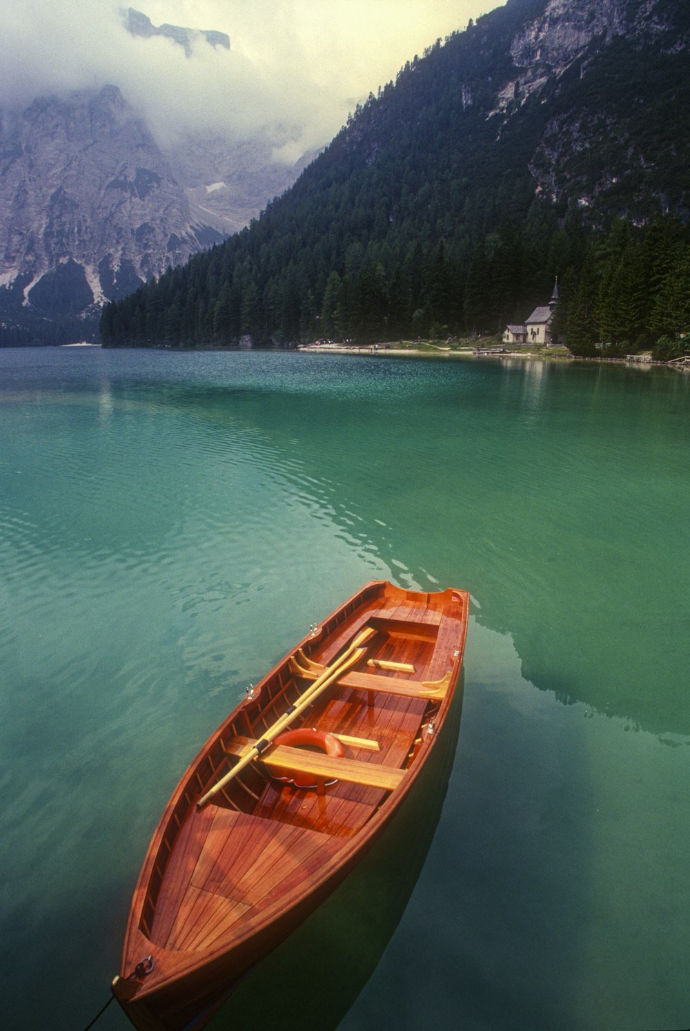 brown wooden boat on body of water during daytime