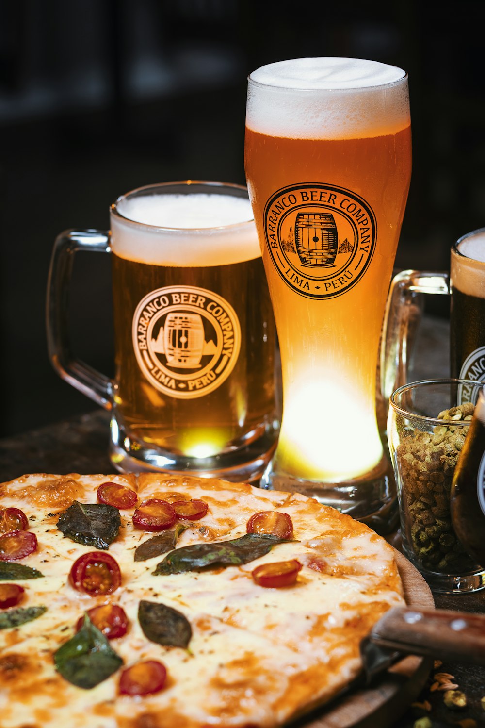 clear drinking glass with beer on brown wooden table