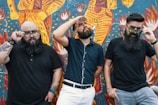 Group of men wearing vanthoryn outfits, leaning against graffiti walls