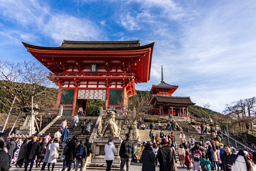 people walking on red and brown temple during daytime