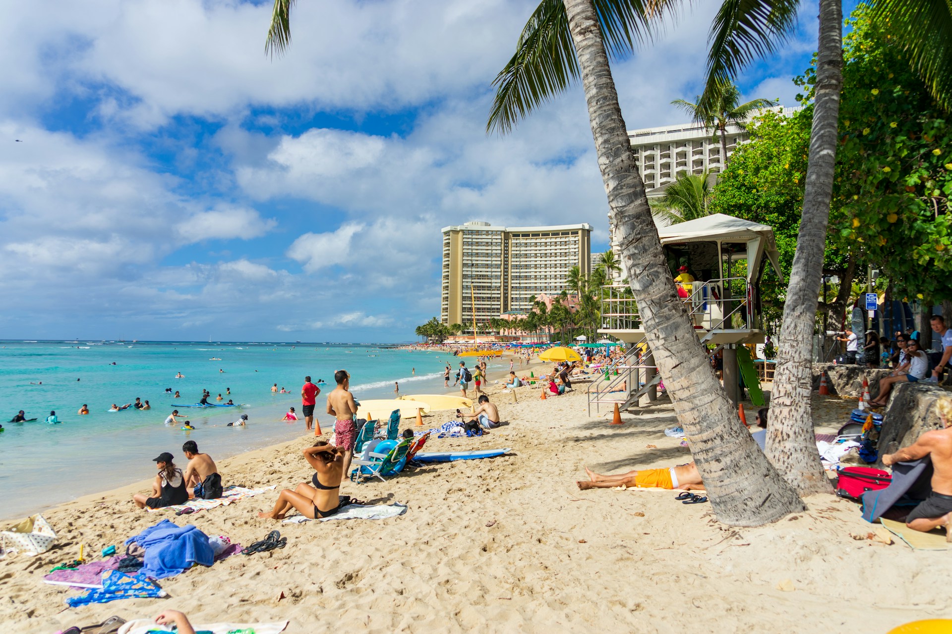 A vibrant beach scene with people enjoying the sun and waves, showcasing the beauty of a Mexican resort.