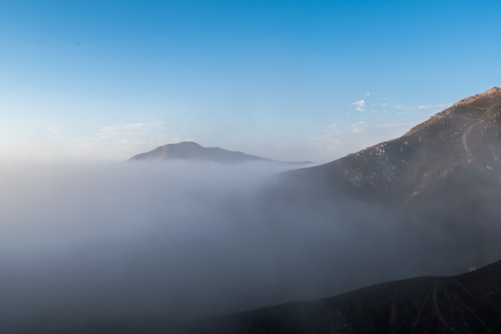 white clouds over mountain during daytime