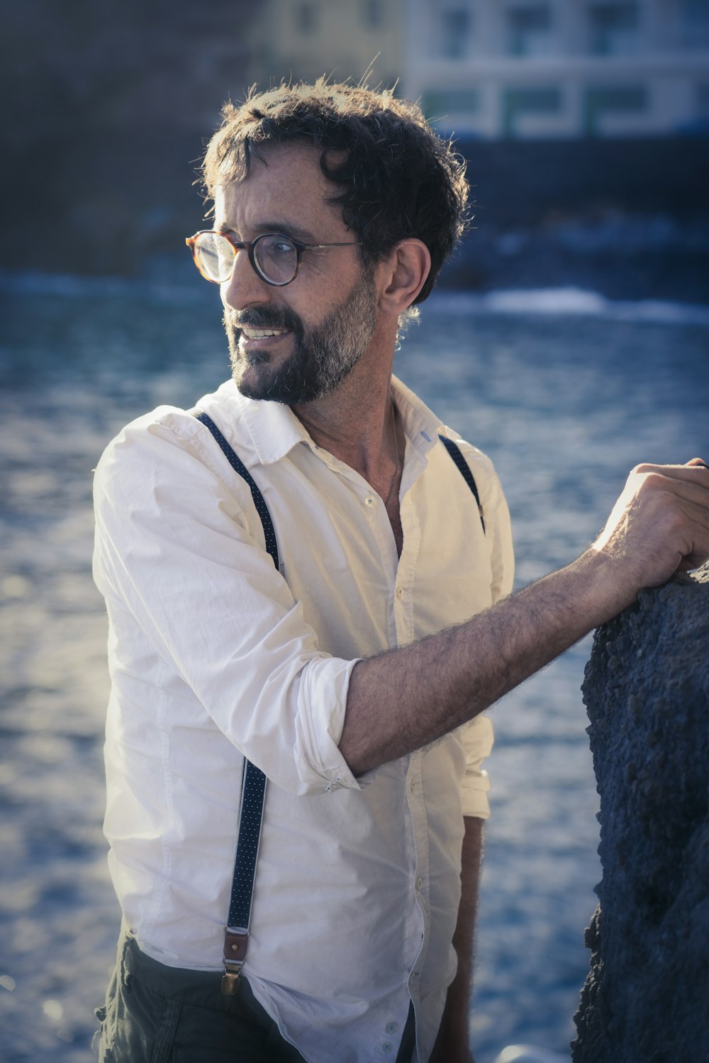 man in white polo shirt wearing black framed eyeglasses