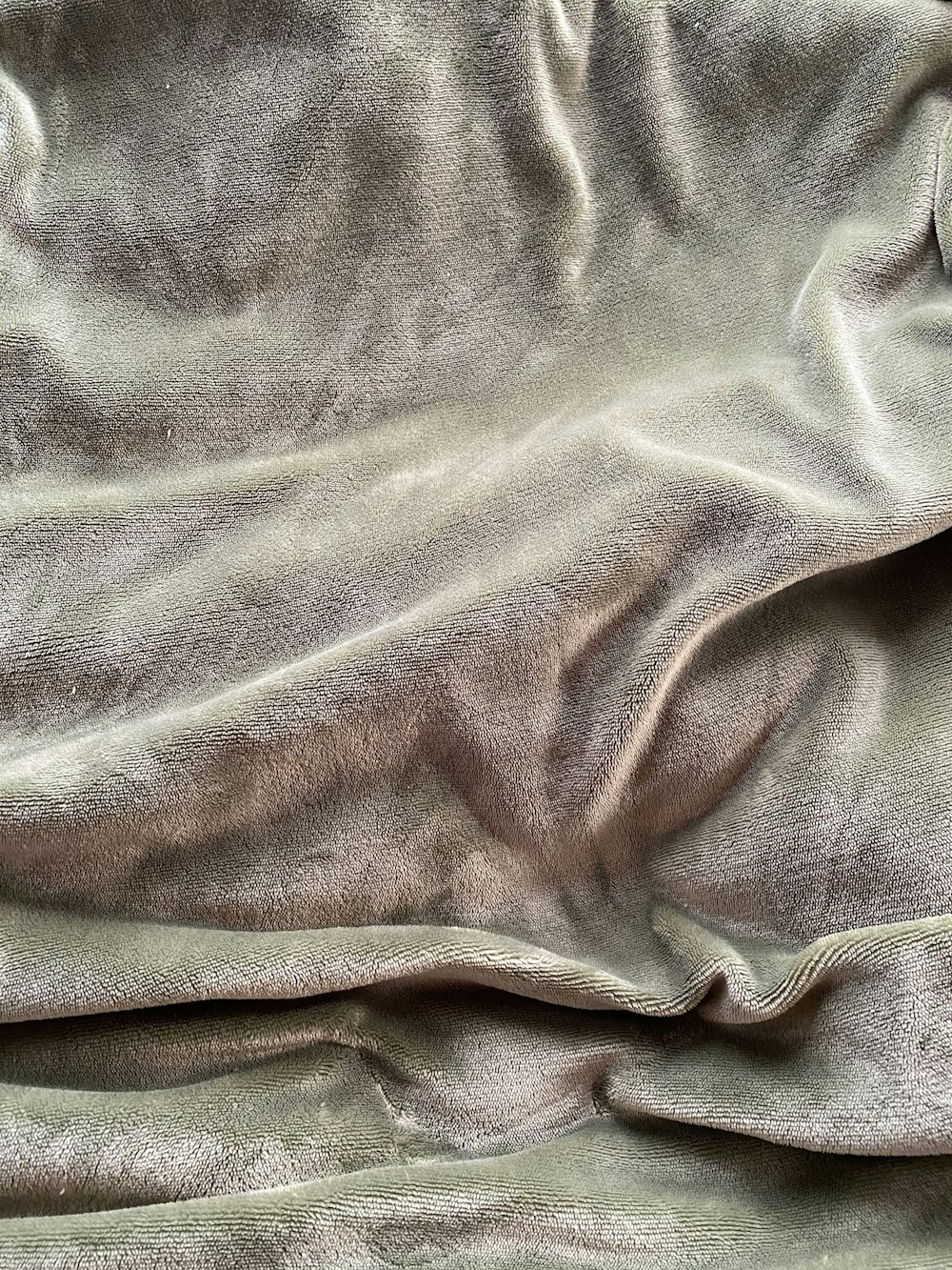 graues Textil auf braunem Holztisch