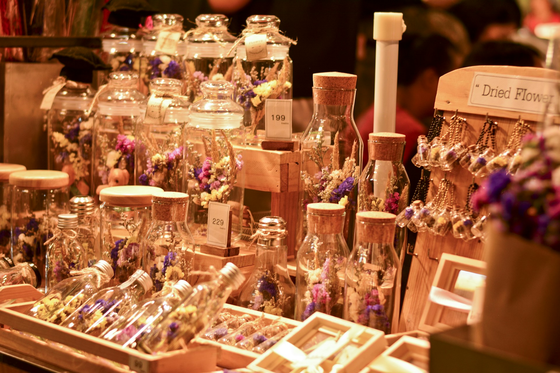 clear glass bottle on brown wooden shelf