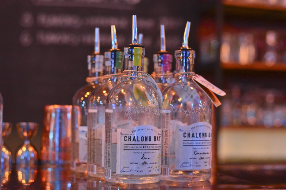 clear glass bottles on brown wooden table