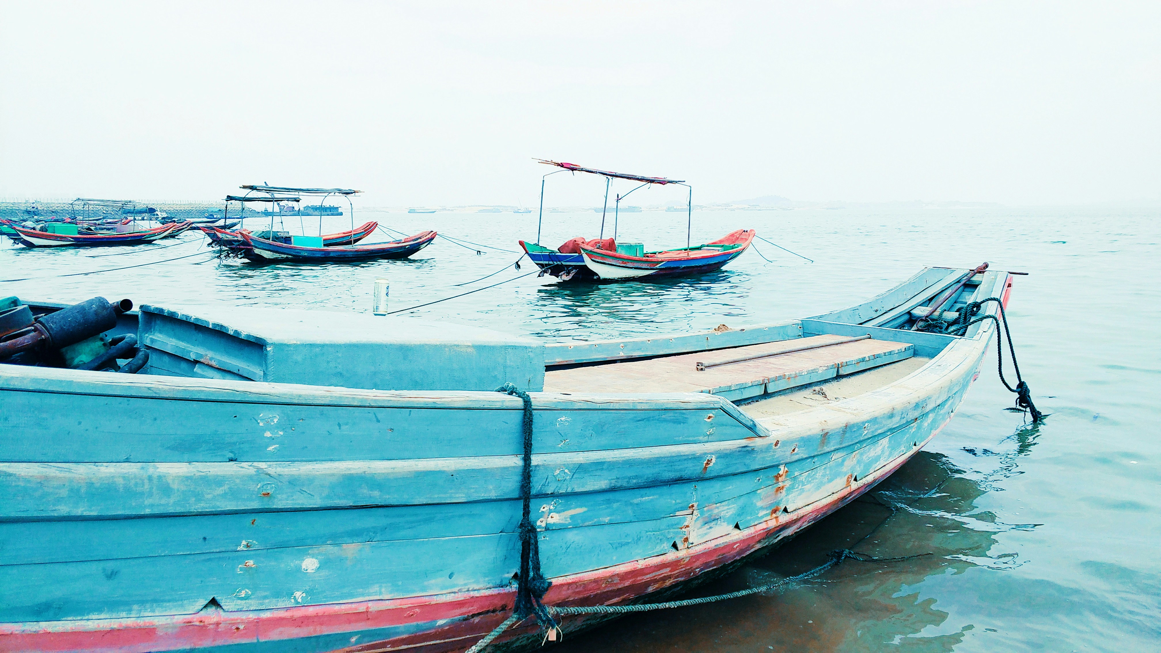 blue and brown wooden boat on body of water during daytime