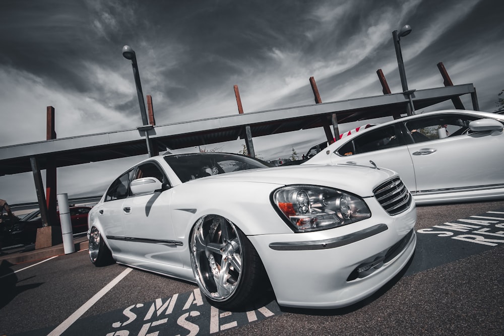 white bmw m 3 coupe on parking lot