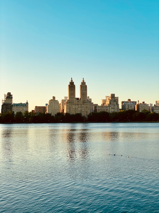 body of water near city buildings during daytime in Jacqueline Onassis Reservoir United States