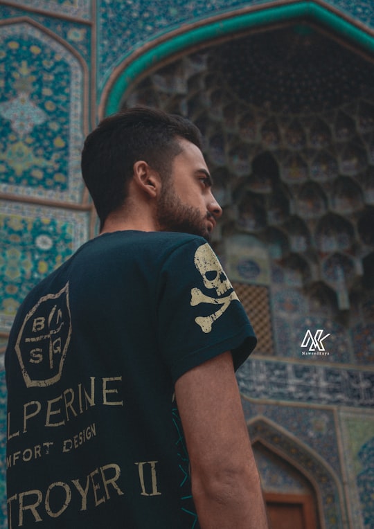 man in black crew neck t-shirt standing near wall in Esfahan Iran