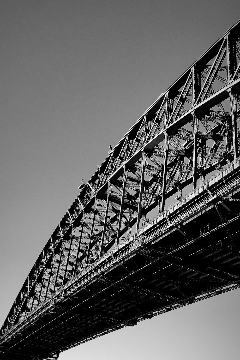 grayscale photo of metal bridge