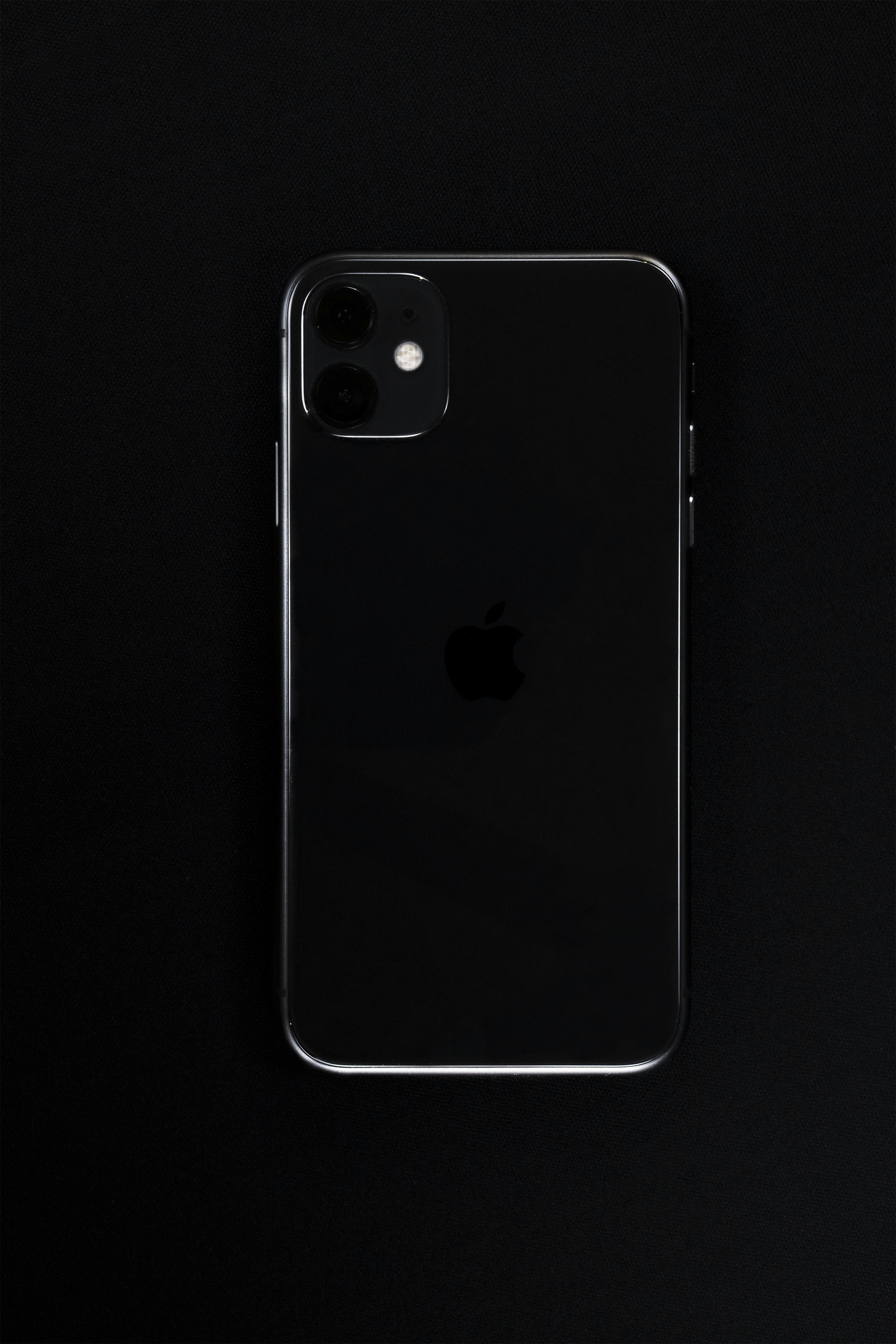 new iPhone 11 on black background silhouette