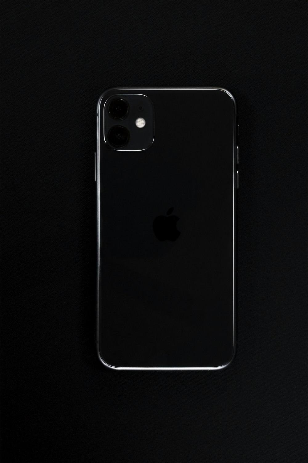 silver iphone 6 on black surface