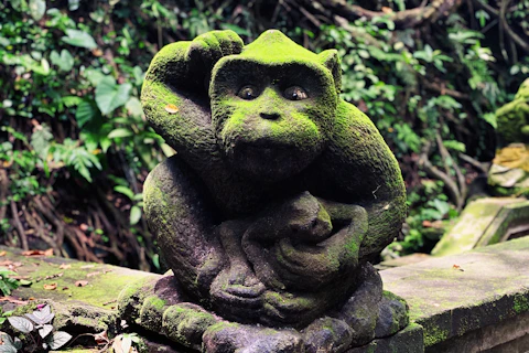 green concrete statue of a frog