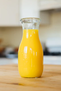 yellow liquid in clear glass bottle